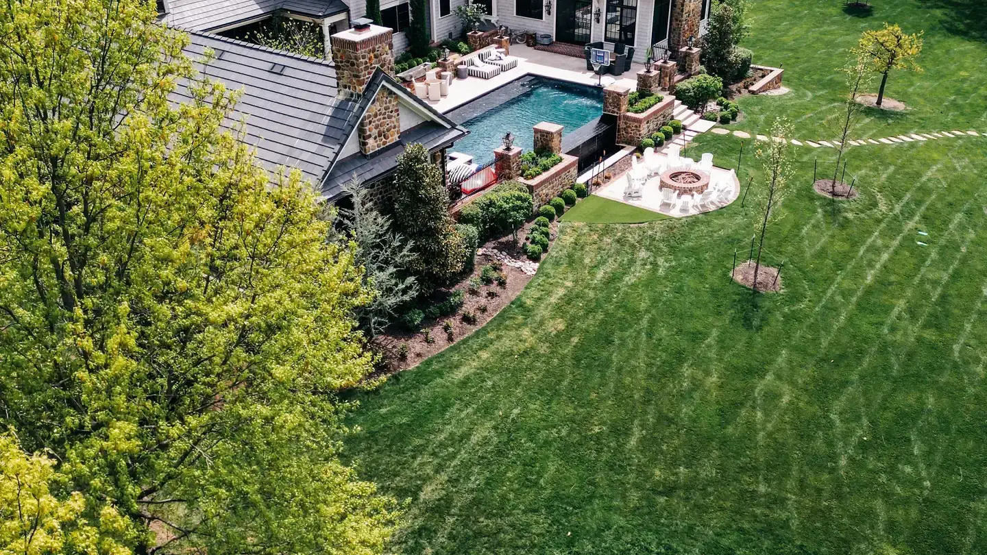 Aerial view of a large residential property and its tree cover
