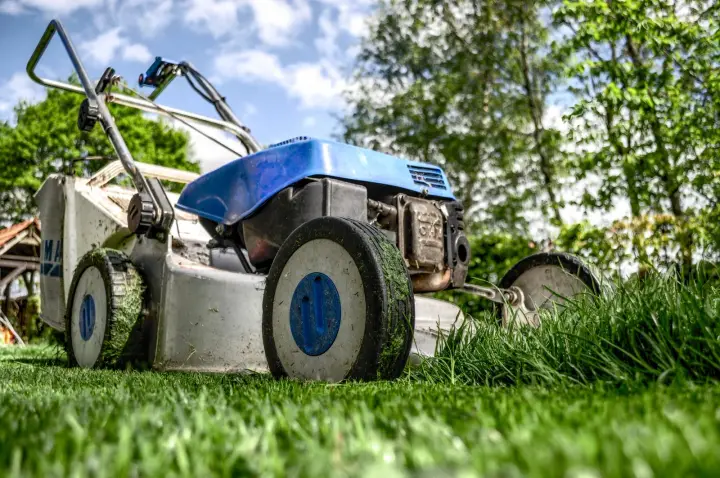 Walk-behind mower cutting a residential lawn